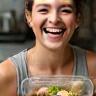 Happy client showing meal prep success